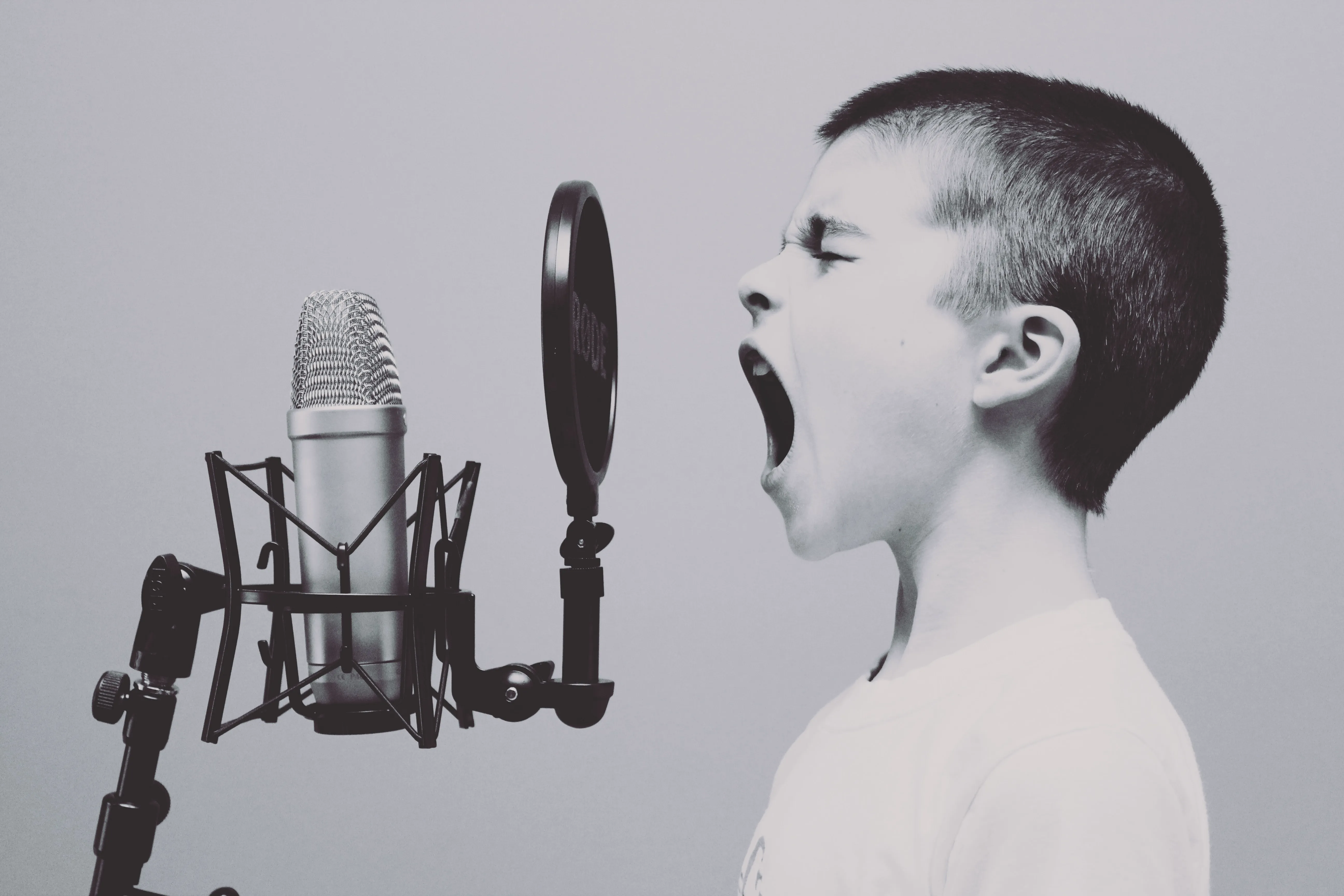 Boy shouting into a microphone
